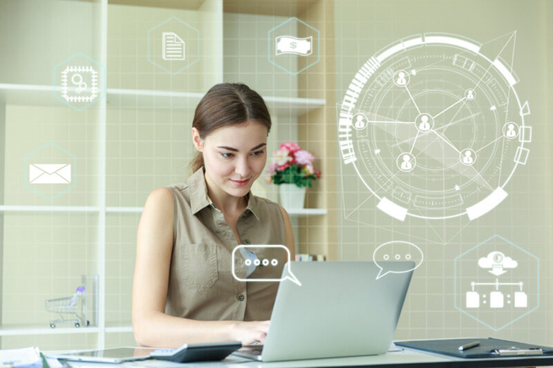 woman working at laptop with digital overlay