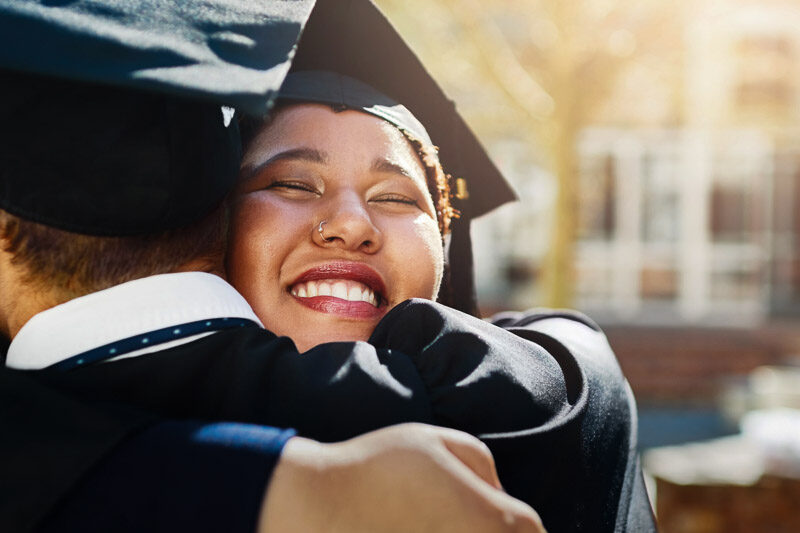university graduates hugging