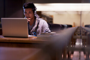 university student at laptop in library