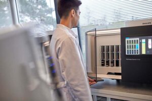 Lab technician using a pathology scanner