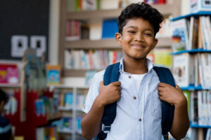 young student smiling at camera in classroom