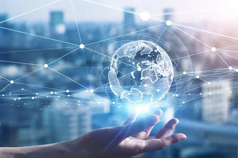 hand supporting globe with digital connections