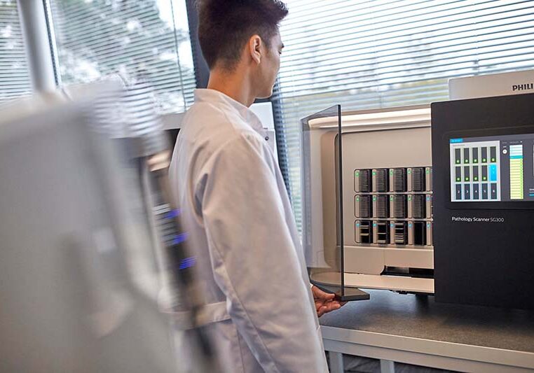Philips Lab technician using a pathology scanner