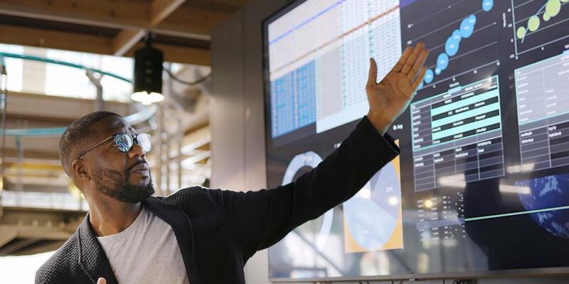 man presenting graphs