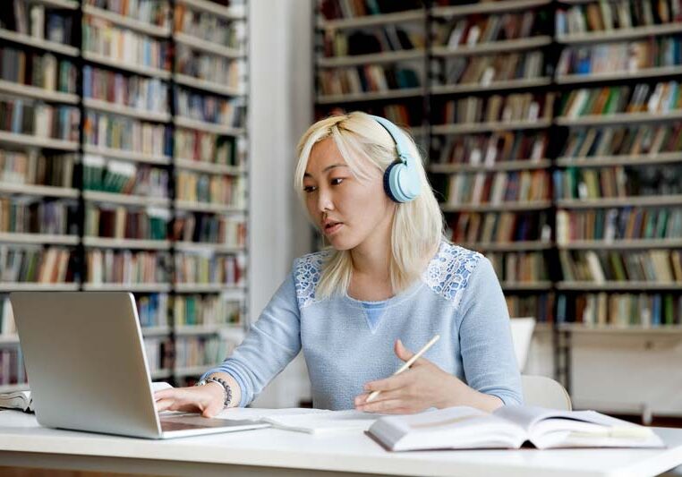 woman at laptop in a library